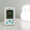 Thermomètre hygromètre BBLUV dans une chambre Thermomètre hygromètre BBLUV posé sur un meuble blanc, à côté d'une veilleuse en forme de hibou